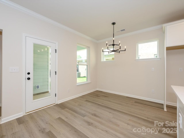 unfurnished dining area featuring visible vents, baseboards, an inviting chandelier, crown molding, and light wood finished floors