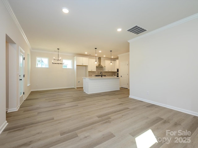 unfurnished living room with a chandelier, recessed lighting, visible vents, and crown molding
