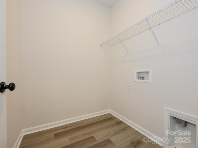 laundry room featuring laundry area, baseboards, hookup for a washing machine, and wood finished floors
