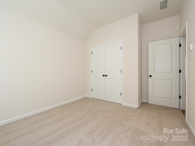 unfurnished bedroom featuring a closet, baseboards, carpet, and visible vents