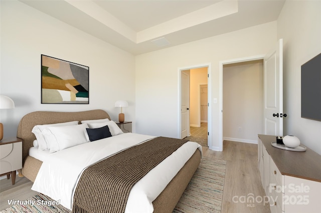 17025 Malone Ln, Mint Hill, NC 28227 - bedroom featuring light wood-style flooring, a raised ceiling, and baseboards