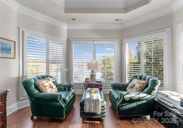 living area featuring dark wood finished floors, visible vents, and a healthy amount of sunlight