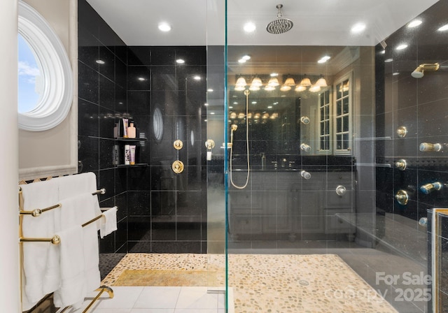 full bathroom with tile patterned floors, tile walls, and walk in shower