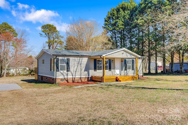 manufactured / mobile home with a porch, a front yard, and crawl space