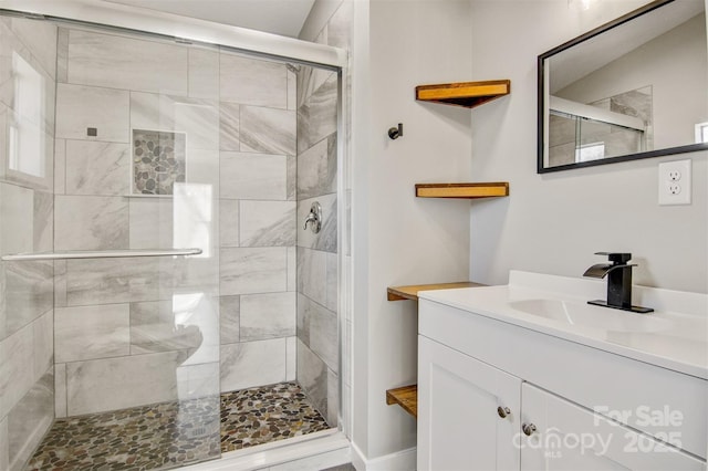 full bathroom featuring a stall shower and vanity