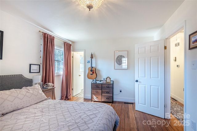 bedroom featuring dark hardwood / wood-style flooring