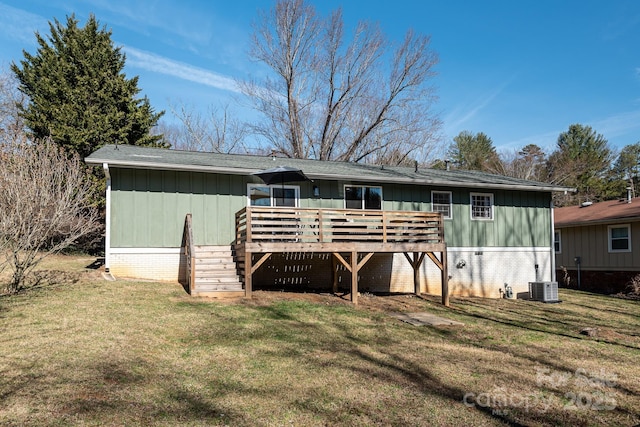 back of property with a yard and a wooden deck