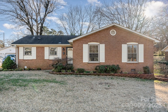 ranch-style house with a garage and a front yard