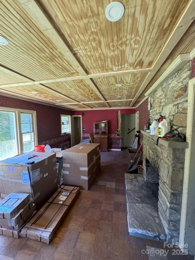 miscellaneous room with a stone fireplace and wood ceiling