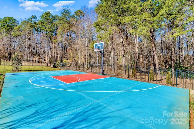 view of basketball court featuring a lawn