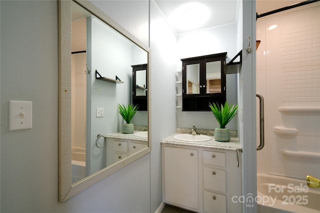 full bath featuring vanity, bathtub / shower combination, and ornamental molding