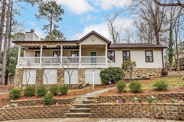 view of front of home featuring a porch, a chimney, and stairs