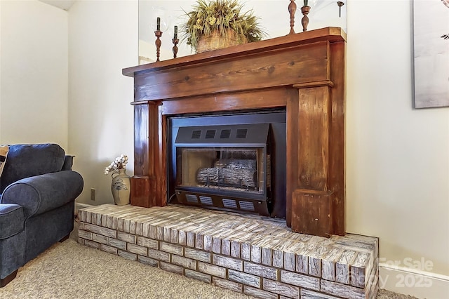 interior details with carpet and a brick fireplace