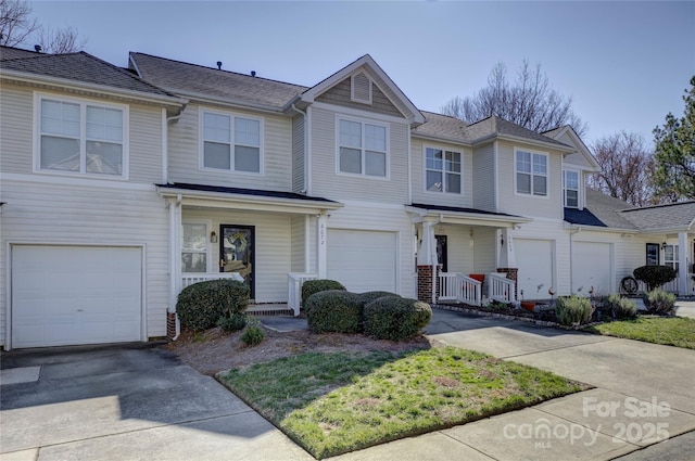 view of front of property with a garage, covered porch, and driveway