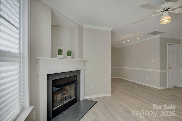 unfurnished living room featuring light wood-type flooring, visible vents, crown molding, and a high end fireplace