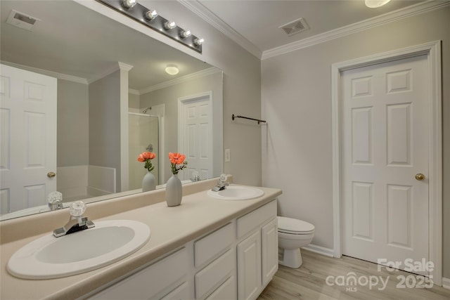 full bathroom featuring crown molding, visible vents, a sink, and a shower stall