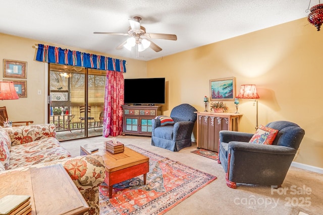 living room featuring ceiling fan, a textured ceiling, and light colored carpet