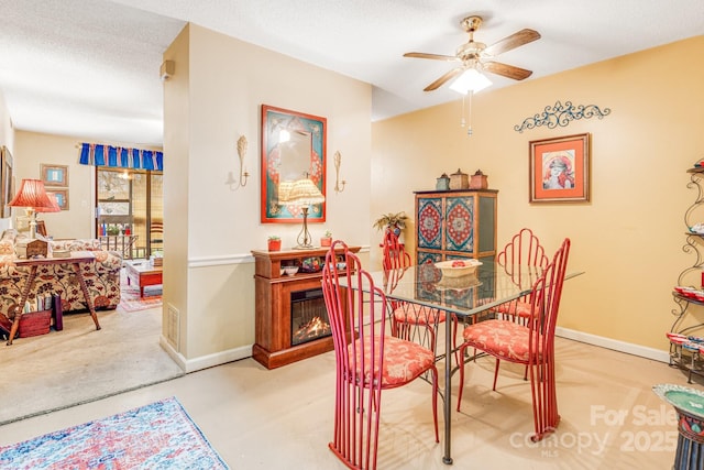 dining area featuring a textured ceiling and ceiling fan