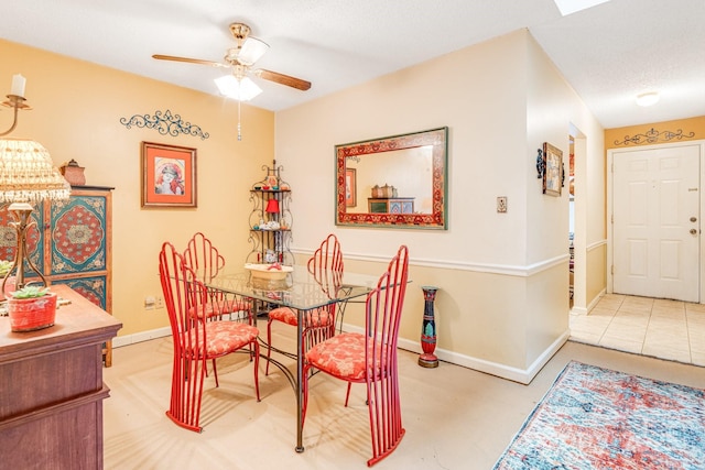 dining room with ceiling fan and a textured ceiling