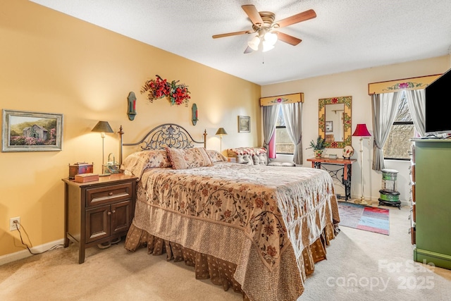 carpeted bedroom featuring multiple windows, ceiling fan, and a textured ceiling