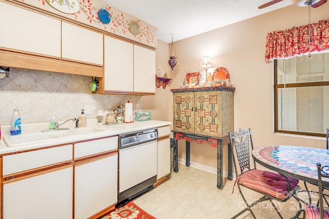 kitchen with dishwasher, a textured ceiling, white cabinets, backsplash, and sink