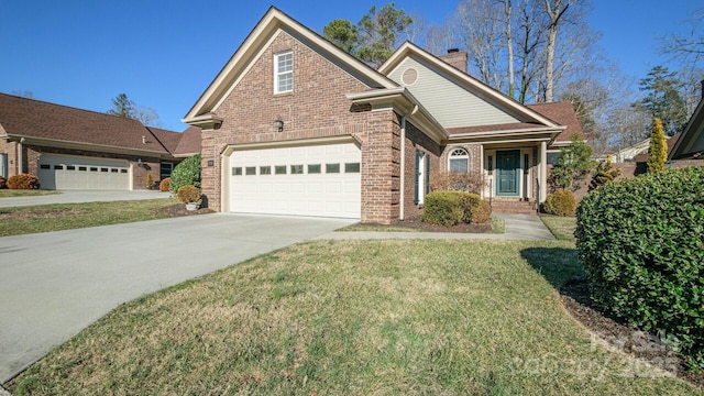 traditional-style house with a chimney, a front lawn, concrete driveway, and brick siding