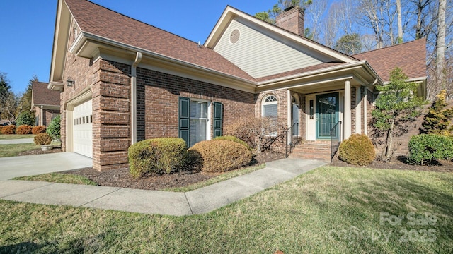 view of front of house featuring brick siding, a chimney, an attached garage, and a front lawn