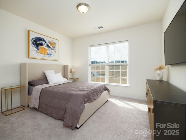 bedroom featuring light colored carpet, visible vents, and baseboards