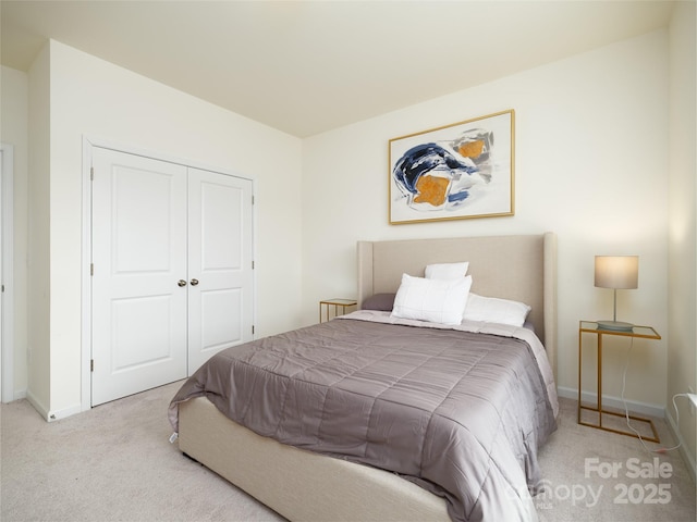 bedroom with a closet, carpet, and baseboards