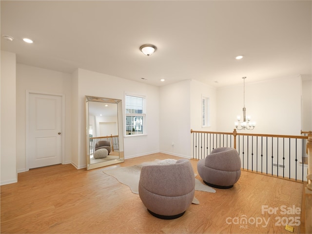 sitting room featuring an inviting chandelier, light wood-style flooring, and recessed lighting