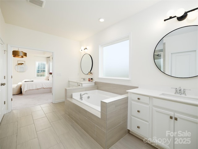 full bath with a garden tub, recessed lighting, visible vents, vanity, and ensuite bath