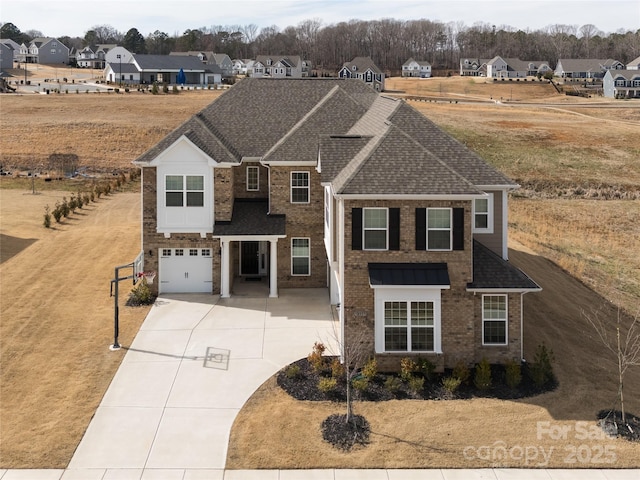 traditional-style home with an attached garage, brick siding, driveway, roof with shingles, and a residential view