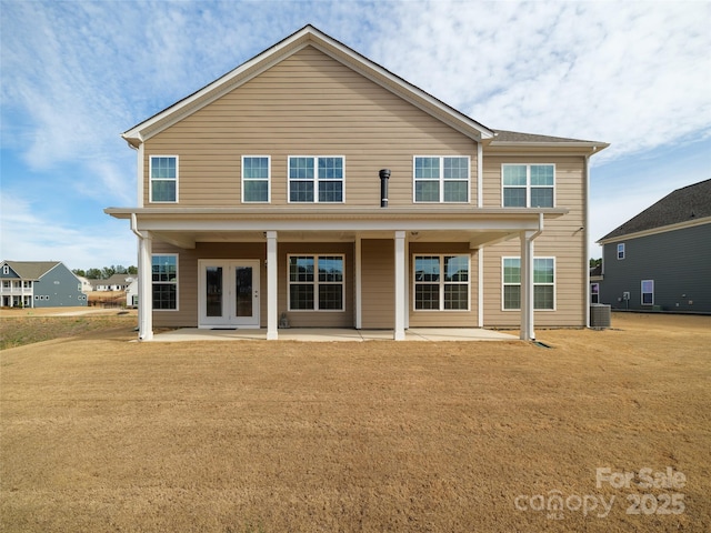 rear view of property with french doors, central AC, and a patio