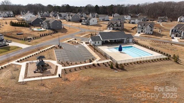 view of pool with a residential view and fence