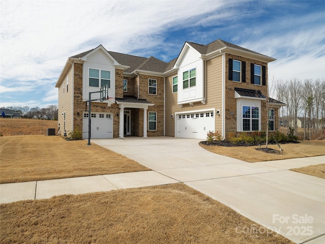 traditional-style home with a garage, cooling unit, brick siding, and driveway