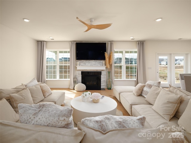 living room with ceiling fan, plenty of natural light, a fireplace, and recessed lighting