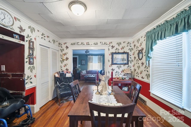 dining space featuring dark hardwood / wood-style flooring and crown molding