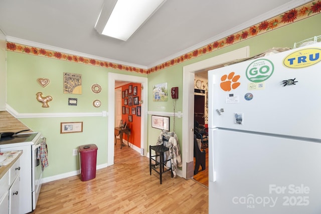 kitchen featuring ornamental molding, white appliances, white cabinets, and light hardwood / wood-style floors