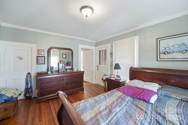 bedroom with dark hardwood / wood-style flooring and ornamental molding