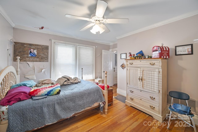 bedroom featuring ceiling fan, crown molding, and hardwood / wood-style floors