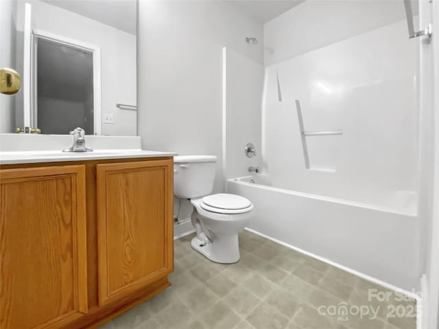 full bath featuring toilet, tile patterned floors, bathing tub / shower combination, and vanity