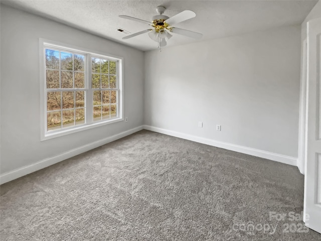 unfurnished room with carpet, visible vents, and baseboards