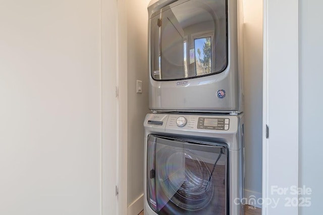 clothes washing area featuring laundry area and stacked washer / drying machine