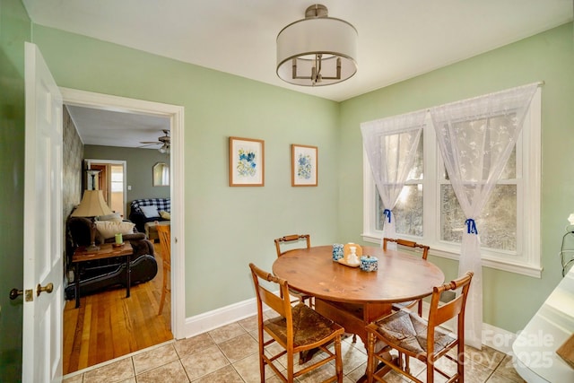 dining area featuring light tile patterned flooring and baseboards