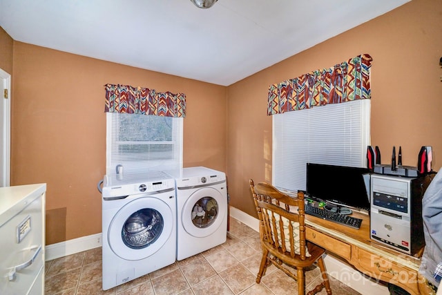 washroom with light tile patterned floors, washing machine and dryer, laundry area, and baseboards