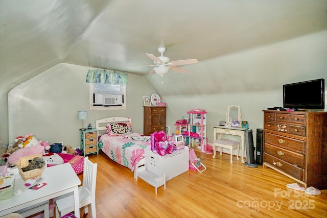 bedroom featuring lofted ceiling, cooling unit, wood finished floors, and a ceiling fan