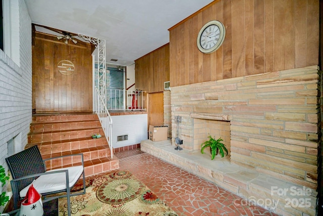 interior space with visible vents, wooden walls, and stairs