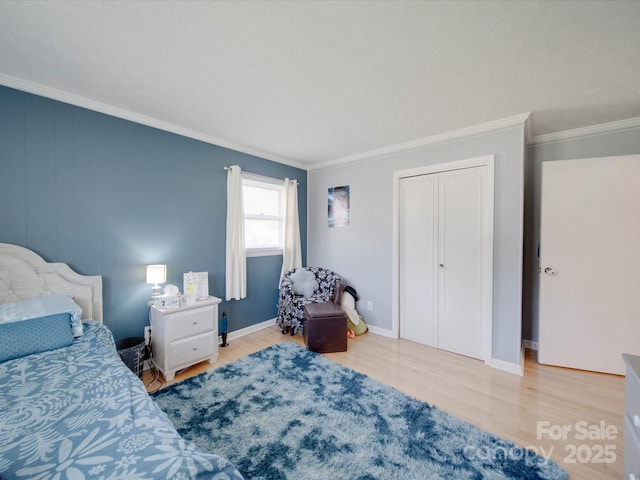 bedroom with ornamental molding and light hardwood / wood-style floors