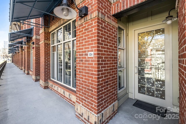 property entrance with brick siding