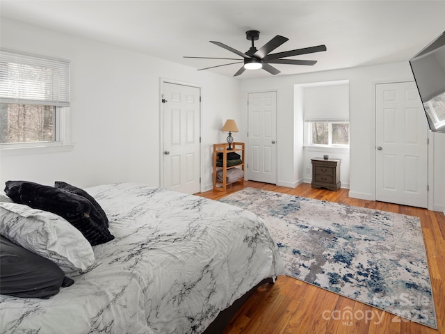 bedroom with light hardwood / wood-style floors and ceiling fan